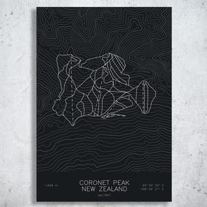 May include: A black poster featuring white topographic contour lines of Coronet Peak, New Zealand. The text reads: Coronet Peak, New Zealand, est 1947, 1,649 m, 44 55 00 S, 168 44 21 E. The design includes white lines representing ski trails.