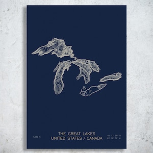 May include: A dark blue rectangular print featuring a white topographic map of the Great Lakes in the United States and Canada. The text reads THE GREAT LAKES UNITED STATES / CANADA, 1,332 ft, and the coordinates 45° 17' 56" N 83° 56' 38" W.