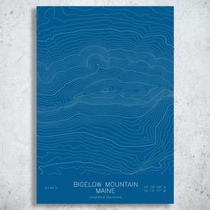 May include: A rectangular print featuring a blue background with white topographic contour lines of Bigelow Mountain, Maine. The text reads Bigelow Mountain, Maine, Longfellow Mountains, 4,145 ft, and the coordinates 45 08 48 N 70 17 17 W.