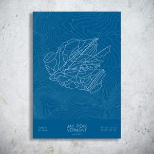 May include: A blue poster featuring a white topographic map of Jay Peak, Vermont. The design includes white contour lines, ski trail paths, and text reading JAY PEAK VERMONT, est 1957, 3968 ft, 81 trails, and coordinates 44 56 15 N 72 31 32 W.