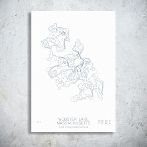 May include: A white print featuring a blue topographic map of Webster Lake, Massachusetts. The text reads WEBSTER LAKE MASSACHUSETTS, Lake Chaubunagungamaug, 45 ft, and the coordinates 42 02' 29" N 71 50' 34" W. The design uses thin blue lines.