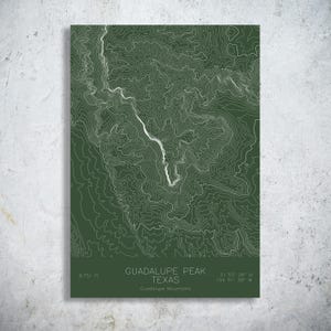 May include: A rectangular wall art print featuring a dark green background with white topographic contour lines of Guadalupe Peak, Texas. The text reads Guadalupe Peak, Texas, Guadalupe Mountains, 8,751 ft, and coordinates 31 53' 28" N 104 51' 38" W.