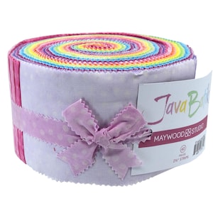 May include: A roll of colorful fabric strips, featuring a rainbow of hues at the top and a light purple dotted fabric on the sides. A light purple ribbon with a bow wraps around the roll. The label reads "Java Batik" and "MAYWOOD Studio".