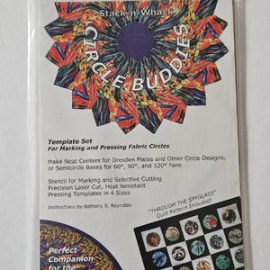 May include: A clear plastic package containing a template set for marking and pressing fabric circles. The package features colorful floral designs and the text "Stack-n-Whack Circle Buddies". Includes a quilt pattern and instructions.