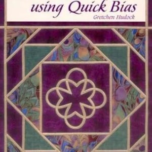 May include: Book cover with the title "Quick Quilts using Quick Bias" by Gretchen Hudock. The cover features a purple and green quilt block with a floral pattern.