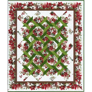 May include: A rectangular quilt featuring a central pattern of intersecting green fabric strips layered over a white background with floral clusters of red and white poinsettias. The quilt is framed by a brown border and a wide floral outer border.