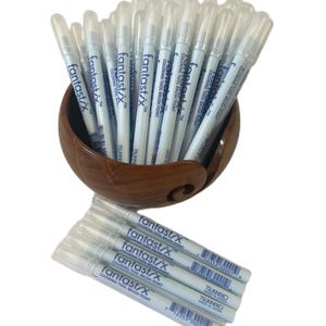 May include: A group of white paint markers with blue lettering that reads "fantastix™ Coloring Tool Brush Point" and "TSUKINEKO MADE IN JAPAN".