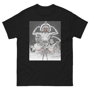 Può includere: T-shirt nero con una grafica di tre uomini in un ring di boxe. La grafica è in bianco e nero con un accento rosso. Il testo "POATANA" è in fondo alla grafica.