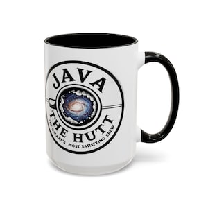 May include: White ceramic mug with a black rim and handle. The mug features a black and white logo with the text "Java The Hutt The Galaxy's Most Satisfying Brew". The logo also includes a stylized image of a coffee cup with a galaxy inside.