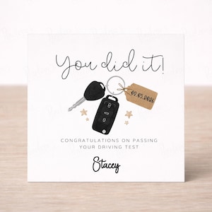 May include: A white card with the words "You did it!" and "Congratulations on passing your driving test". The card features illustrations of car keys, a key fob, and small stars. The name "Stacey" is written at the bottom.