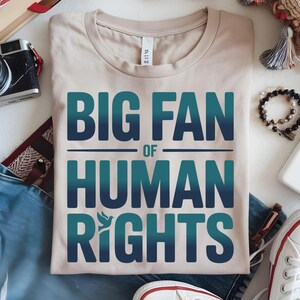 shirt with bold “Big Fan of Human Rights” quote in gradient blue-green letters, featuring a peace dove icon; perfect for social justice advocates, activism events, equality supporters, and human rights awareness.