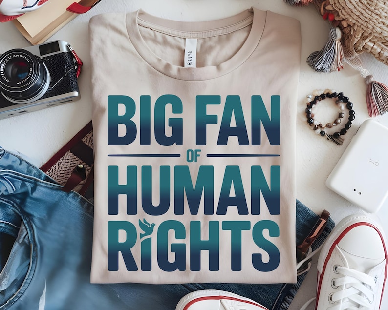 shirt with bold “Big Fan of Human Rights” quote in gradient blue-green letters, featuring a peace dove icon; perfect for social justice advocates, activism events, equality supporters, and human rights awareness.