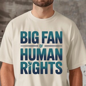 shirt with bold “Big Fan of Human Rights” quote in gradient blue-green letters, featuring a peace dove icon; perfect for social justice advocates, activism events, equality supporters, and human rights awareness.