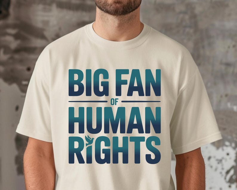shirt with bold “Big Fan of Human Rights” quote in gradient blue-green letters, featuring a peace dove icon; perfect for social justice advocates, activism events, equality supporters, and human rights awareness.