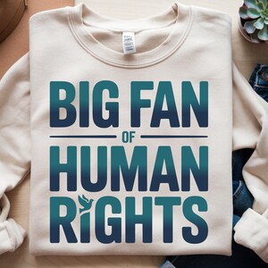 shirt with bold “Big Fan of Human Rights” quote in gradient blue-green letters, featuring a peace dove icon; perfect for social justice advocates, activism events, equality supporters, and human rights awareness.