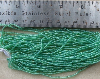 Czech Jablonex Ornela Preciosa seed beads, peridot green AB, 11/0, full hank, temporarily strung