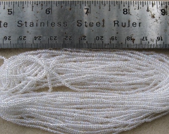 Czech Jablonex Ornela Preciosa seed beads, crystal AB, 11/0, full hank, 12 strands, temporarily strung