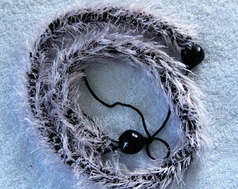 Black and light pink crocheted eyelash lei, finished with black kukui nuts, handmade in Hilo, Hawaii