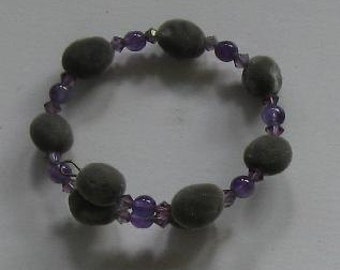 May include: A gray and purple beaded bracelet with small round gray beads and small purple crystal beads.