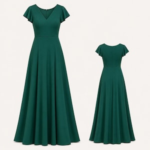 May include: A forest green formal dress with a V-neckline and short flutter sleeves. The dress has a fitted bodice and a flowing A-line skirt. A second view of the dress shows the back with a similar silhouette.