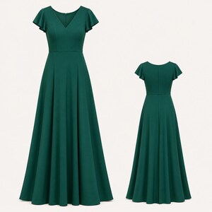 May include: A forest green, floor-length dress with a V-neckline and short, flutter sleeves. The dress features a fitted bodice and a flowing A-line skirt. A second image shows the back of the dress. Ideal for formal events.