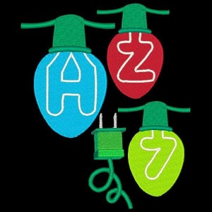 May include: Three light bulbs with the letters A, Z, and Y on them. The bulbs are green, red, and yellow. There is a green electrical plug and cord.