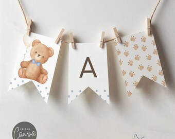 May include: A brown teddy bear holding a balloon with blue polka dots and a blue bow tie. The bear is on a white banner with blue polka dots. The banner says "A" in brown letters. There is a banner with brown paw prints on a white background. The banners are strung together with twine and clothespins.