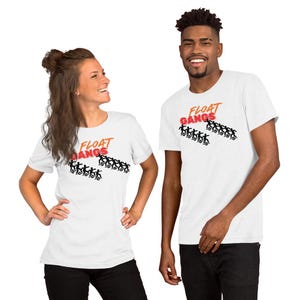 May include: White t-shirts with the text "FLOAT GANGS" in orange and red. The shirts feature a graphic of stick figures. The models are wearing black pants.
