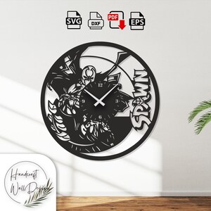 Pode incluir: Relógio de parede preto com tema Spawn com ponteiros brancos. O relógio apresenta uma silhueta detalhada do personagem Spawn e a palavra "SPAWN" em letras em negrito. O relógio tem um design circular, perfeito para um fã de banda desenhada.