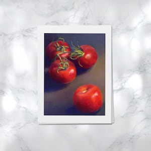 Vertical portrait art prints on archival paper on a kitchen counter, showing red tomatoes on the vine on a moody dark black background. This is a giclee print of my realistic dark oil painting vegetable food still life. 4x6 5x7 8x10 9x12 11x14 inch