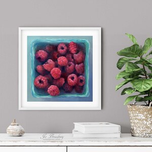 A bright turquoise blue and pink raspberry oil painting art print in a simple elegant picture frame on a dining room or living room wall. Square art print on archival fine art paper of summer fruit still life 4x4 5x5 6x6 8x8 10x10 12x12 inch