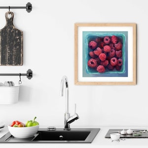 A bright blue and pink raspberry painting art print in a simple elegant picture frame as modern farmhouse kitchen wall art decor. Square art print on archival fine art paper of realism oil painting fruit still life 4x4 5x5 6x6 8x8 10x10 12x12 inch