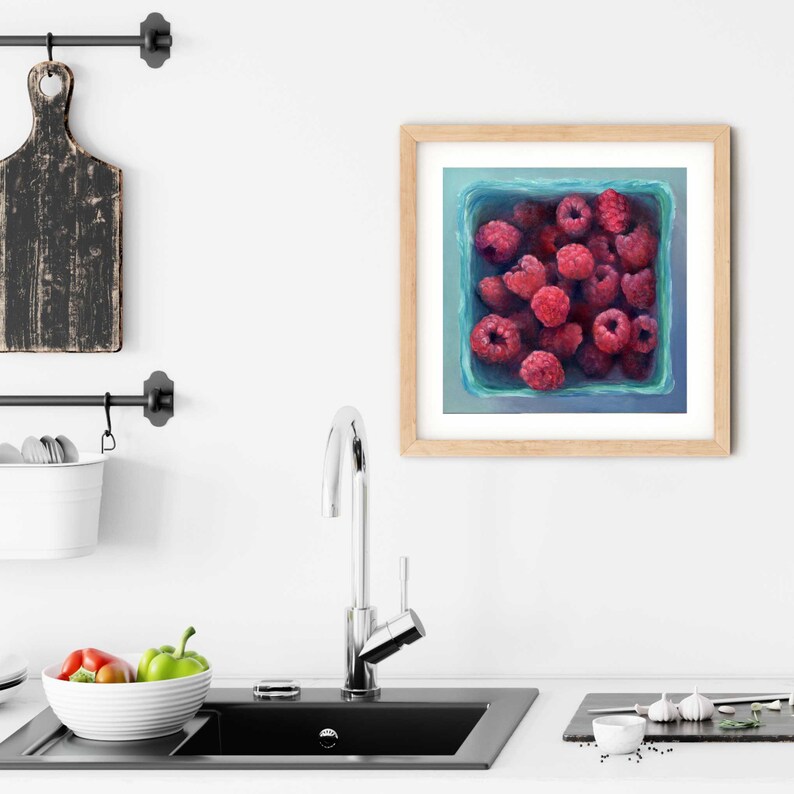 A bright blue and pink raspberry painting art print in a simple elegant picture frame as modern farmhouse kitchen wall art decor. Square art print on archival fine art paper of realism oil painting fruit still life 4x4 5x5 6x6 8x8 10x10 12x12 inch