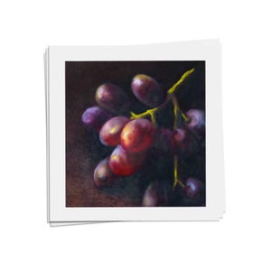 Square art print on archival fine art paper on a kitchen counter showing purple and red grapes with lime green stems emerging from a dramatic wine dark background. Giclee print of my realistic oil painting fruit still life 4x4 5x5 6x6 8x8 10x10 12x12