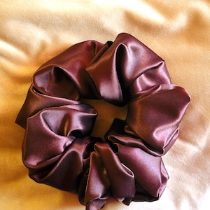 May include: A dark burgundy satin scrunchie for hair.