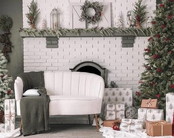 May include: A white tufted sofa with a gray throw blanket sits in front of a white brick fireplace decorated with greenery and Christmas ornaments. The fireplace has a black metal mantel and a black metal fireplace insert. There are wrapped gifts with a Christmas tree design on the floor in front of the sofa.