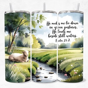 May include: A stainless steel tumbler with a watercolour design showing a sheep in a green pasture with a stream. The text reads "He makes me lie down in green pastures, He leads me beside still waters. Psalm 23:2."
