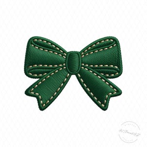 May include: A digitally embroidered green bow with gold stitching. The bow is a classic design, with a central knot and looped ends. The stitching detail adds texture and a handcrafted feel to the design.
