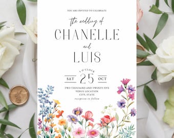 May include: A wedding invitation with a floral border. The invitation reads "You are invited to celebrate the wedding of Chanelle and Luis. Sat 25 Oct. Two thousand and twenty five. Venue location. City, State. Reception to follow."