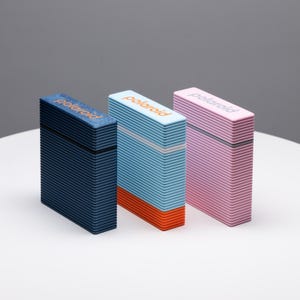 May include: Three Polaroid instant cameras in different colours: blue, light blue with an orange stripe, and pink. Each camera has the word "Polaroid" printed on the front.
