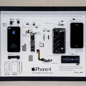 May include: A black framed display showcasing the disassembled components of an iPhone 4. The display includes a black and white schematic diagram of the phone's internal components, along with the text "iPhone 4" and "This changes everything. Again."