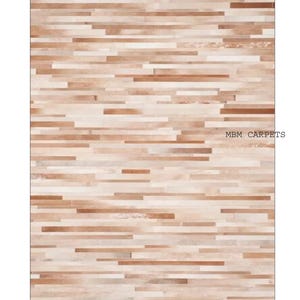 May include: A rectangular rug with a natural wood grain pattern. The rug features horizontal strips of varying shades of brown and beige, creating a textured appearance. The text "MBM CARPETS" is visible in the image.