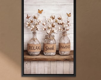 Puede incluir: Impresión artística enmarcada que presenta tres tarros de vidrio con tallos de algodón, etiquetados como "Relax", "Soak" y "Unwind". Los tarros están sobre una repisa de madera contra un fondo de paneles de madera blancos, con mariposas. Una pieza decorativa para un baño.