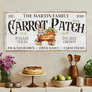 May include: A rectangular wooden sign with the text "Carrot Patch" and "The Martin Family." It features a watercolor illustration of a bunny in a wooden cart filled with carrots. The sign also includes the text "Dallas Texas" and "Locally Grown."