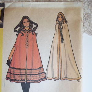 May include: Vintage McCall's sewing pattern for a junior cape in two versions. The pattern is for sizes 5-7 and costs 85 cents. The pattern is printed on a tan background with illustrations of two girls wearing the cape.