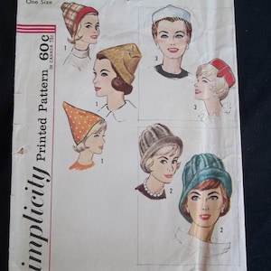 May include: Vintage Simplicity printed pattern 4677 featuring illustrations of various women's hats. The hats include a plaid headband, a beret, a cloche, and a pillbox hat. The pattern is marked "One Size".