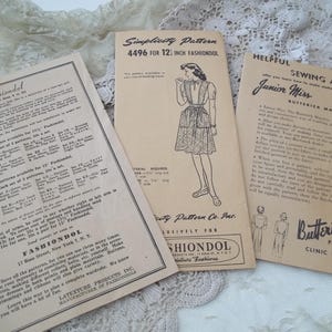 May include: Three vintage sewing pattern leaflets. One features a dress illustration and the text "Simplicity Pattern 4496 FOR 12 INCH FASHIONDOL." Another leaflet is titled "Fashiondol." The third leaflet is titled "Helpful Sewing Aids Junior Miss Butterick Pattern Clinic Digest."