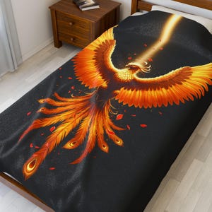 May include: A black and orange phoenix with its wings spread wide, rising from a bed of red embers. The phoenix is surrounded by a dark background with a bright light shining from its body.