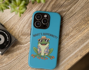 May include: A blue phone case with a cartoon frog wearing sunglasses and a hat. The text "What's Hoppenin?!" is printed on the case.