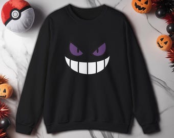 Felpa con sorriso sinistro: pullover con faccia da cartone animato gotico inquietante
